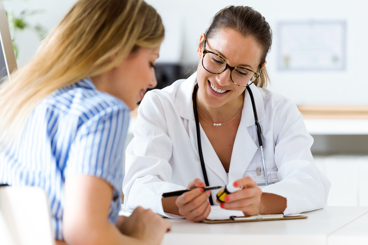 Female doctor prescribing medication for patient. / blog - choosing an OB/GYN